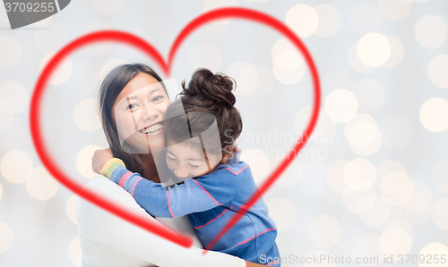 Image of happy mother and daughter hugging