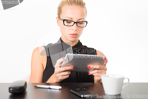 Image of Business woman working on tablet PC.