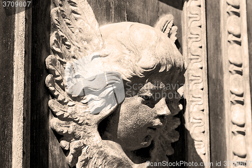 Image of abstract statue of angel     texture of     brown  antique woode