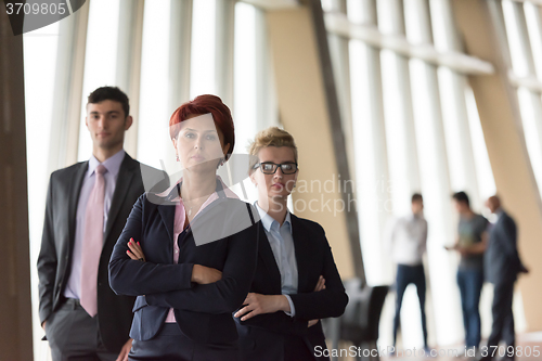 Image of business people group, woman in front  as team leader