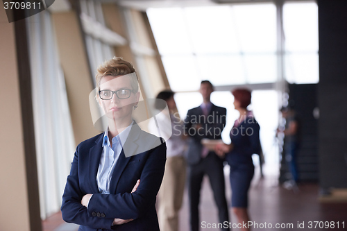 Image of business people group, woman in front  as team leader