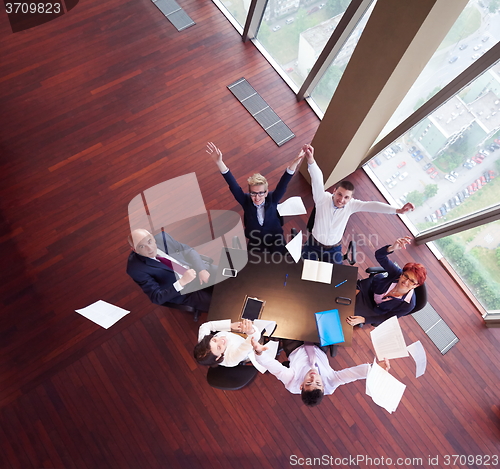 Image of top view of business people group throwing dociments in air