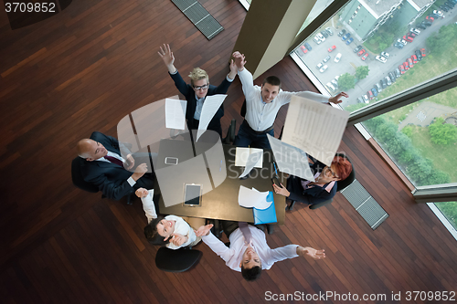 Image of top view of business people group throwing dociments in air