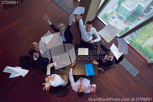 Image of top view of business people group throwing dociments in air