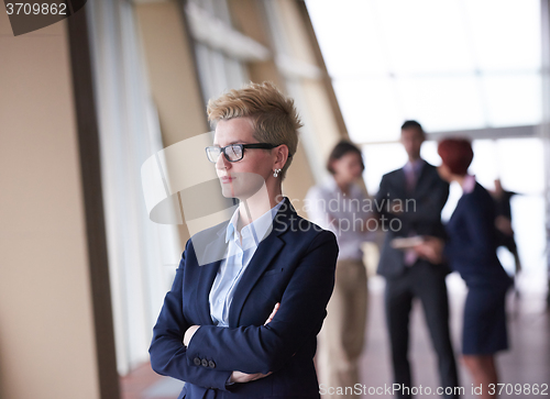 Image of business people group, woman in front  as team leader