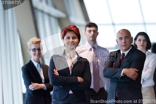 Image of business people group, woman in front  as team leader