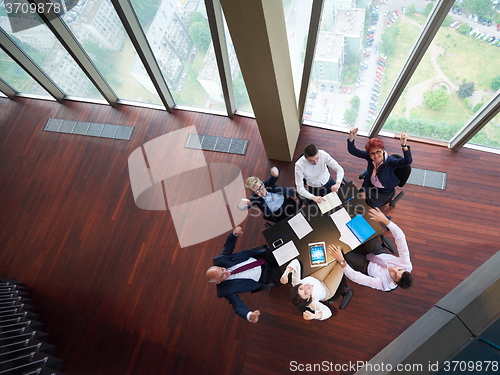 Image of top view of business people group throwing dociments in air