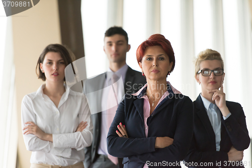 Image of business people group, woman in front  as team leader