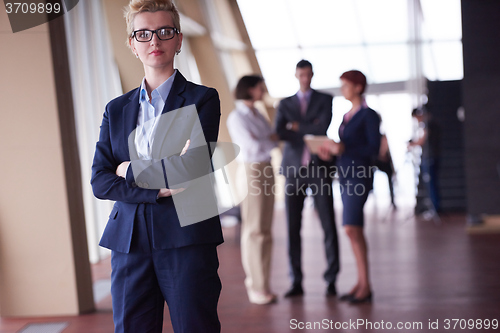 Image of business people group, woman in front  as team leader