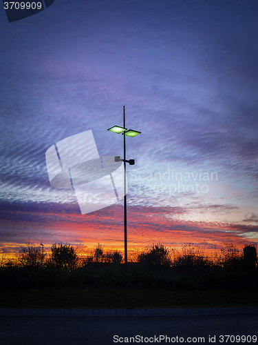 Image of Modern streetlamp at sunset