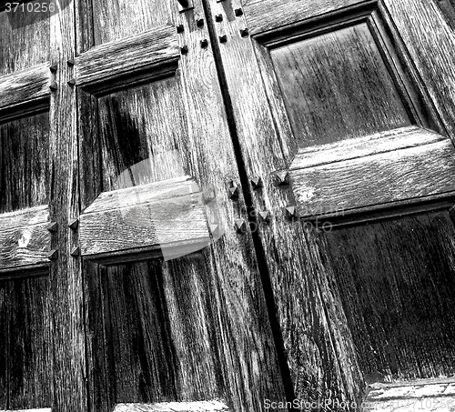 Image of abstract texture of a brown antique wooden old door in italy   e