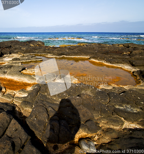 Image of in spain  lanzarote  rock stone sky cloud beach  