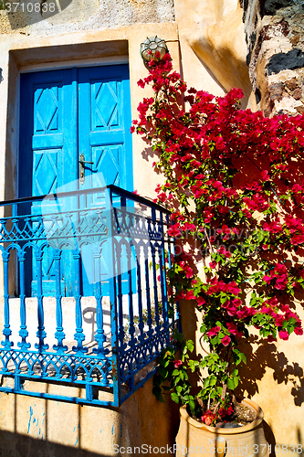 Image of blue door in antique village santorini flower