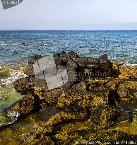 Image of in lanzarote froth coastline  spain pond  rock stone sky cloud b