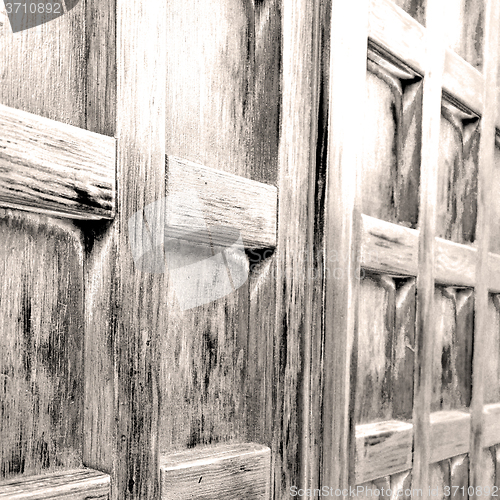 Image of home texture of a brown antique wooden old door in italy   europ