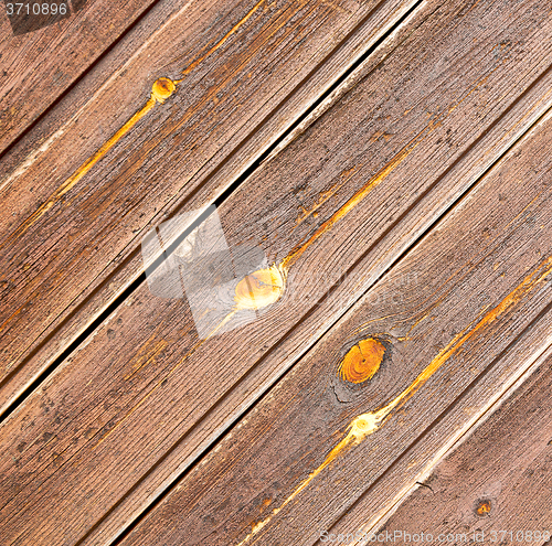 Image of home texture of a brown antique wooden old door in italy   europ