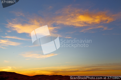 Image of the sunrise in  colored sky white mountain