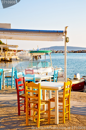 Image of wicker sofa  in santorini  old restaurant  