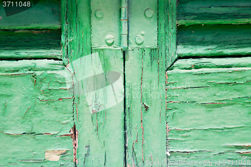 Image of in the old wall a hinged window green wood  