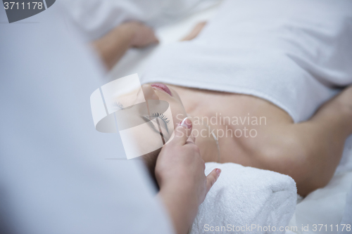 Image of woman getting face and head  massage in spa salon