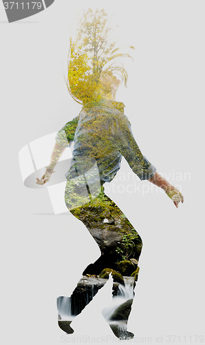 Image of double exposure of nature and  young woman dancing