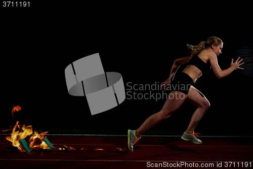 Image of pixelated design of woman  sprinter leaving starting blocks