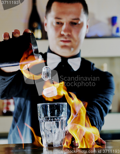 Image of pro barman prepare coctail drink on party