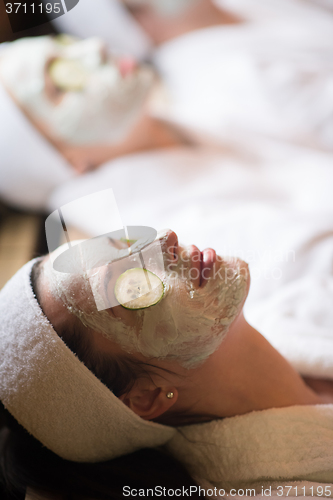 Image of woman in spa  with cosmetic mask