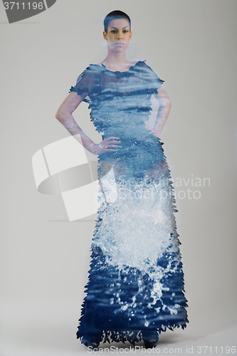 Image of double exposure of elegant woman in fashionable dress posing in 