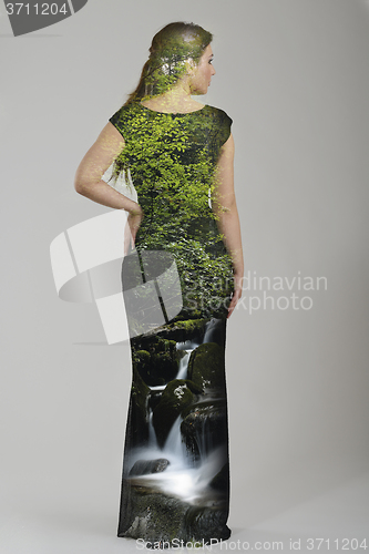 Image of double exposure of elegant woman in fashionable dress posing in 