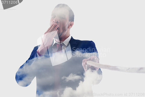 Image of double exposure of business man with rope isolated on white back