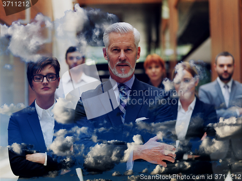 Image of double exposure of senior business man with his team at office