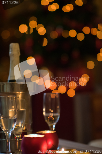 Image of champagne and glasses at home on christmas night