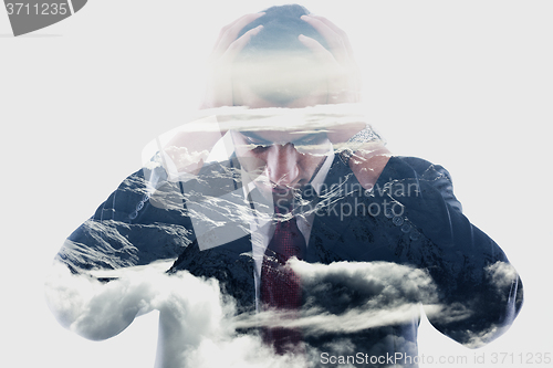 Image of double exposure of depressed business man