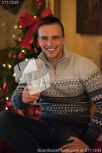 Image of young man with champagne glass  on party