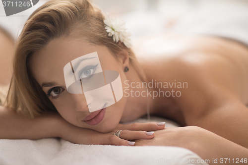 Image of woman getting back massage in spa salon