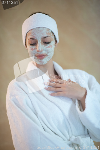 Image of woman in spa  with cosmetic mask