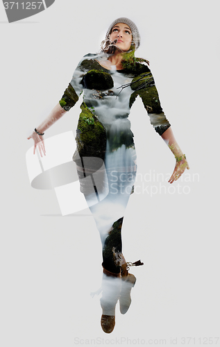 Image of double exposure of nature and  young woman dancing