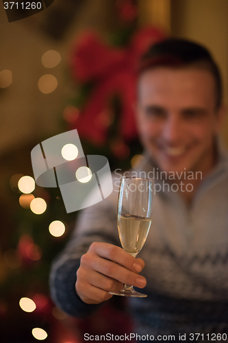 Image of young man with champagne glass  on party