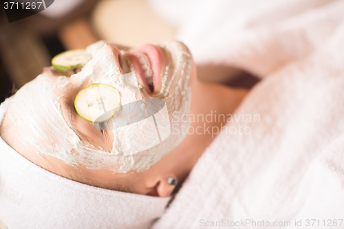 Image of woman in spa  with cosmetic mask
