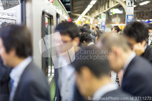 Image of Business people traveling by Tokyo metro.