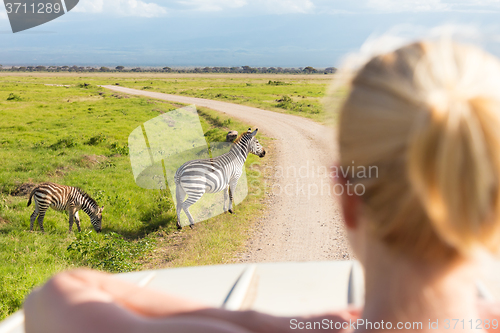 Image of Woman on african wildlife safari.