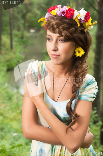 Image of Young beautiful woman in wreath of flowers