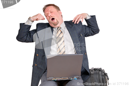 Image of Yawning traveling businessman