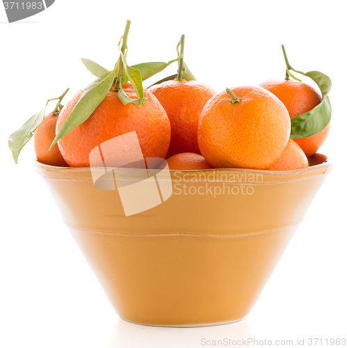 Image of Tangerines on ceramic yellow bowl 