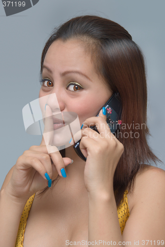 Image of Hushing girl with cellphone