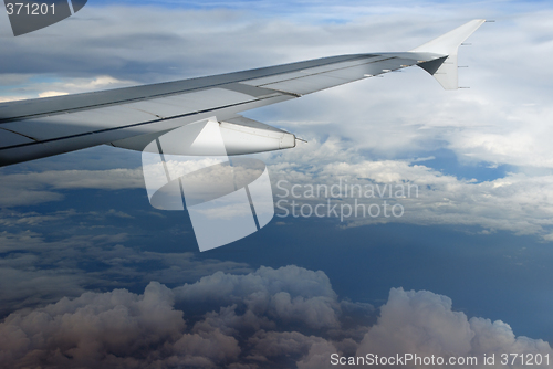 Image of Airplane wing over cloudscape