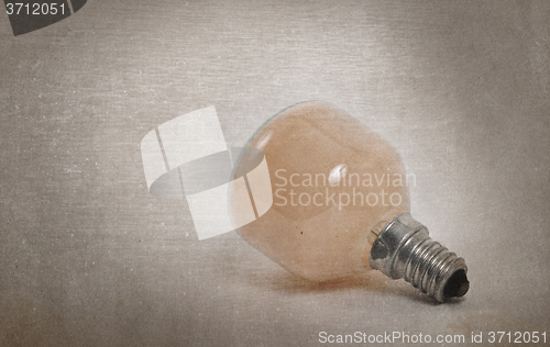 Image of Old orange lightbulb isolated on a white background