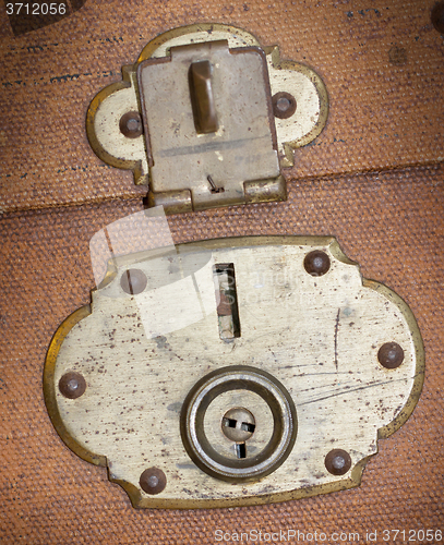 Image of Old canvas trunk lock close up