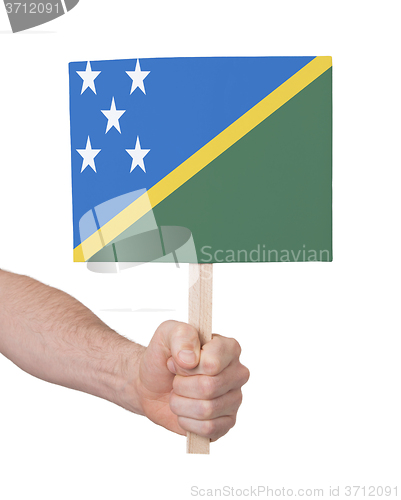 Image of Hand holding small card - Flag of Solomon Islands